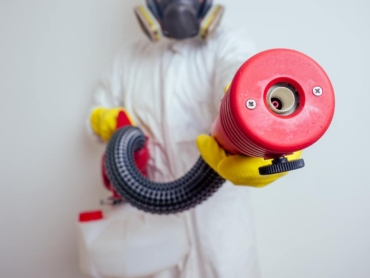 pest-control-worker-spraying-pesticides-with-sprayer-apartment-copy-spase-white-walls-background